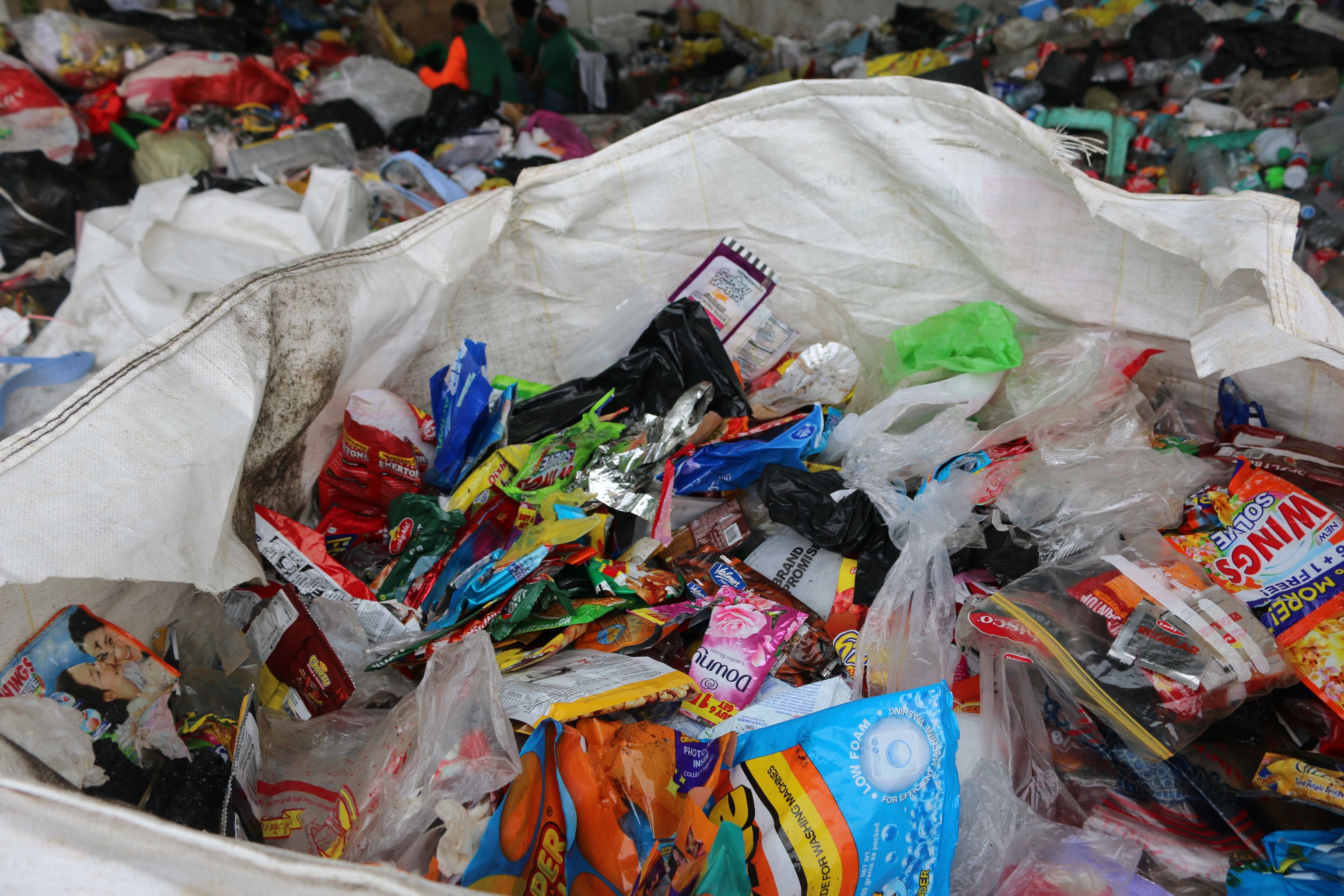 Sorted plastics are placed into sacks.