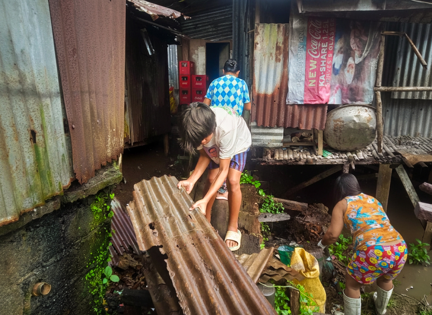 Houses stand above the plastic-choked waters of Barangay Mabua, where the MARITES along with their families are working together to clean their community.
