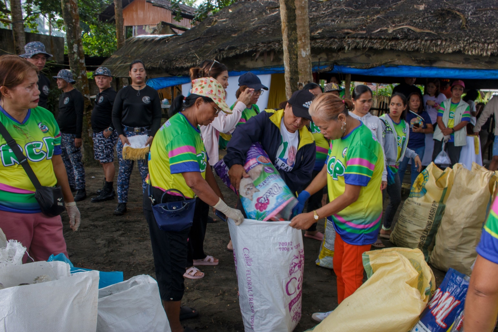 MARITES members haul and weigh collected plastics from their coastal cleanup for the World Ocean Day.