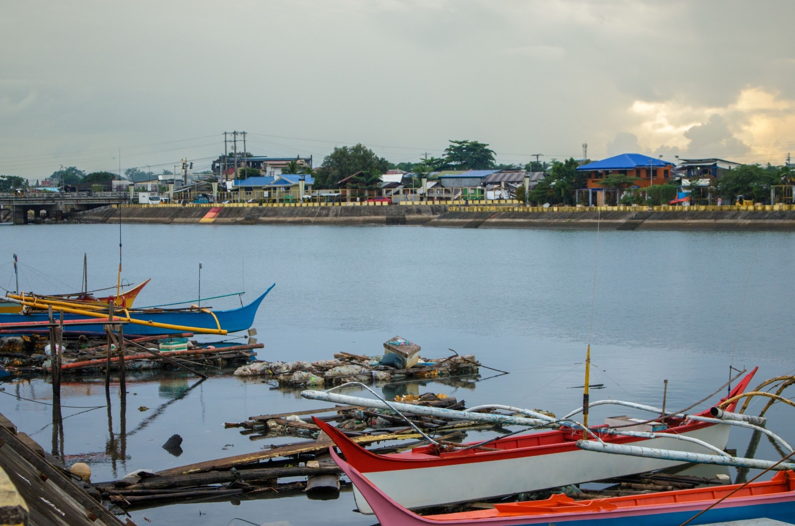 Discarded floaters drift along the riverbanks of Barangay San Agustin Sur, a fishing community.